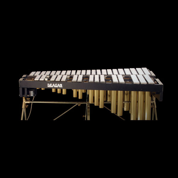 Deagan vibraphone musical instrument with metal bars and resonators on a stand, on a black background.