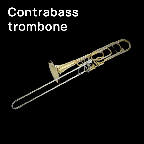 Gold and silver contrabass trombone on a black background.