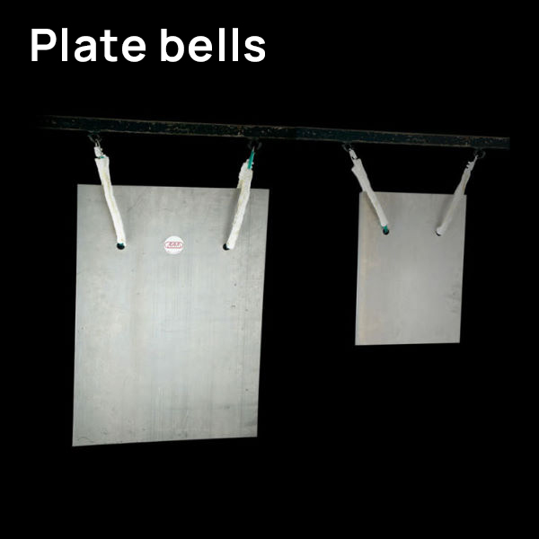Two rectangular metal plate bells of different sizes, a larger one on the left and a smaller one on the right, hanging from a horizontal bar against a black background.
