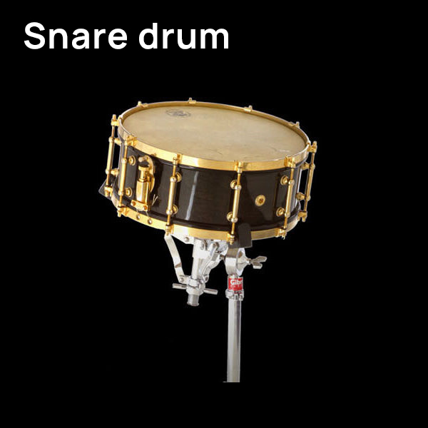 Dark wood snare drum with brass hardware on a chrome stand, original image.