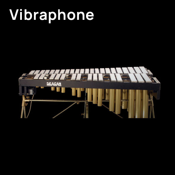 Deagan vibraphone musical instrument with metal bars and resonators on a stand, on a black background.