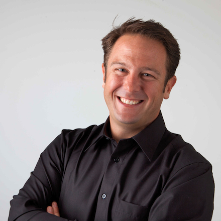 Paul Kopf smiling wearing a black collared shirt, with crossed arms. Head of Product Marketing, Social Media & Support.