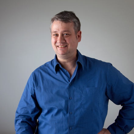 Manfred Rojnik, IT Hardware Manager, smiling while wearing a blue shirt