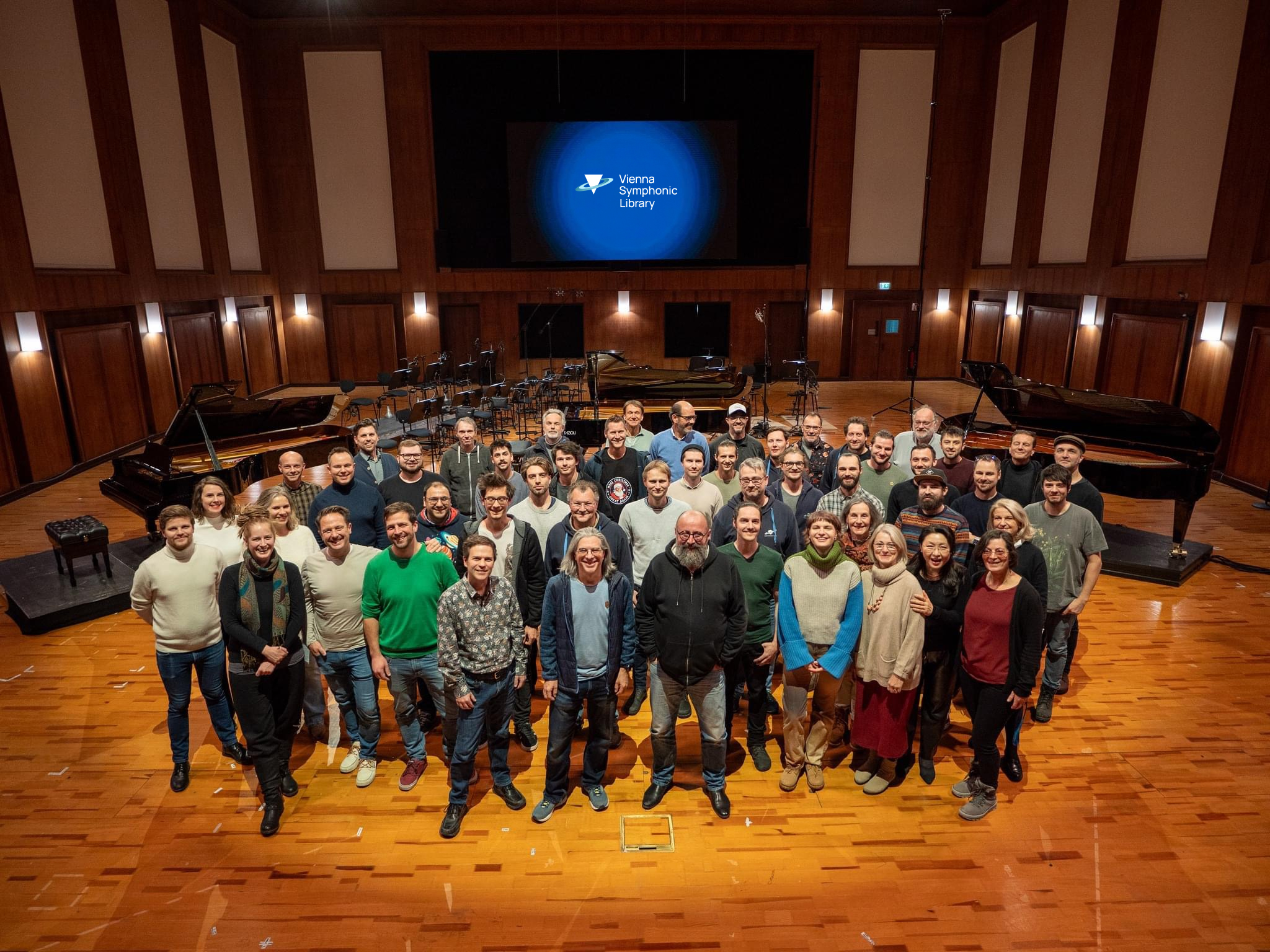 Large team of music professionals from Vienna Symphonic Library in a recording studio.