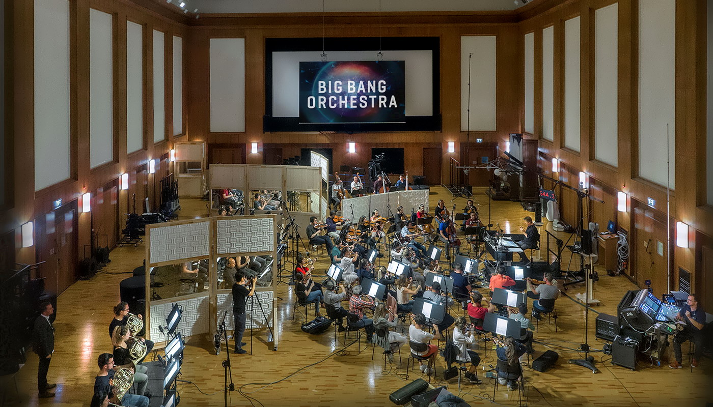 Full orchestra recording the Big Bang Orchestra Synchron Instruments at Vienna Symphonic Library Studio, with large screen displaying BIG BANG ORCHESTRA.