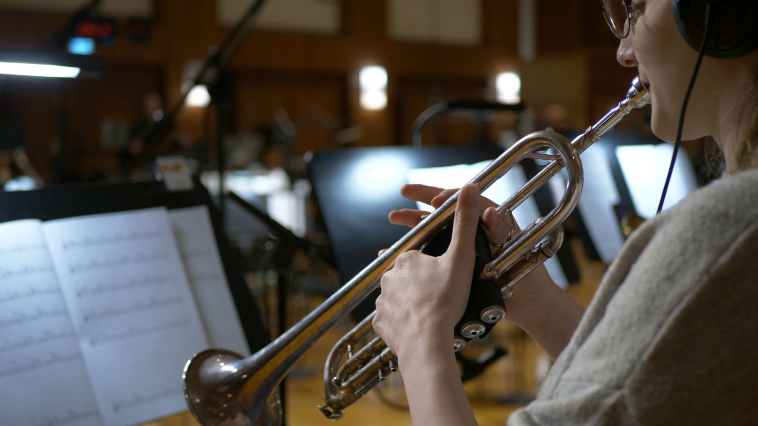Synchron Percussion II: A variety of orchestral percussion instruments, including gongs, cymbals, and small bells, arranged on stands in a recording studio or concert hall.