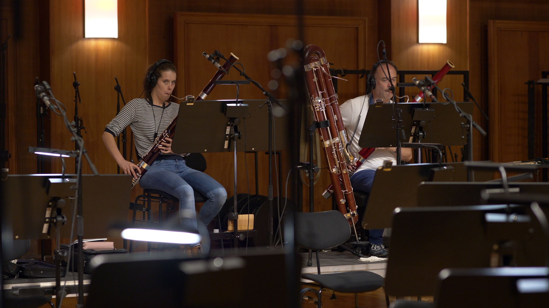 Multiple large metal sheet percussion instruments, possibly thunder sheets or gongs, arranged on stands in a recording studio or concert hall.