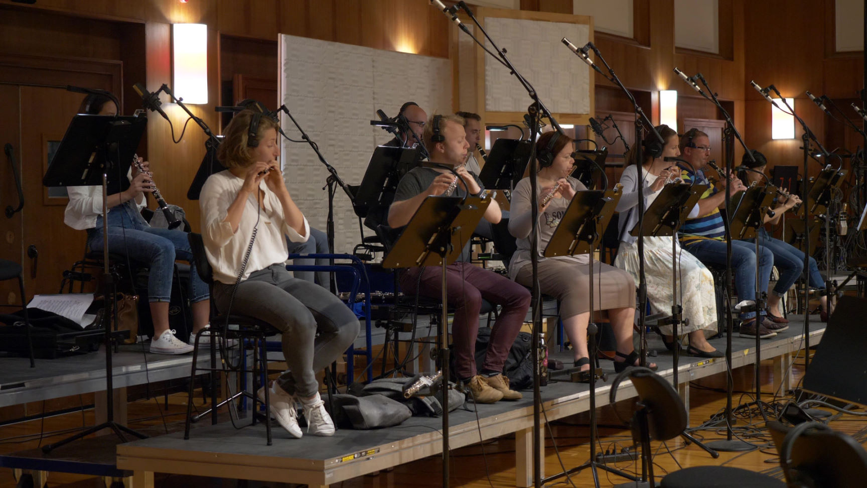 Synchron Percussion II: A variety of orchestral percussion instruments, including gongs, cymbals, and small bells, arranged on stands in a recording studio or concert hall.