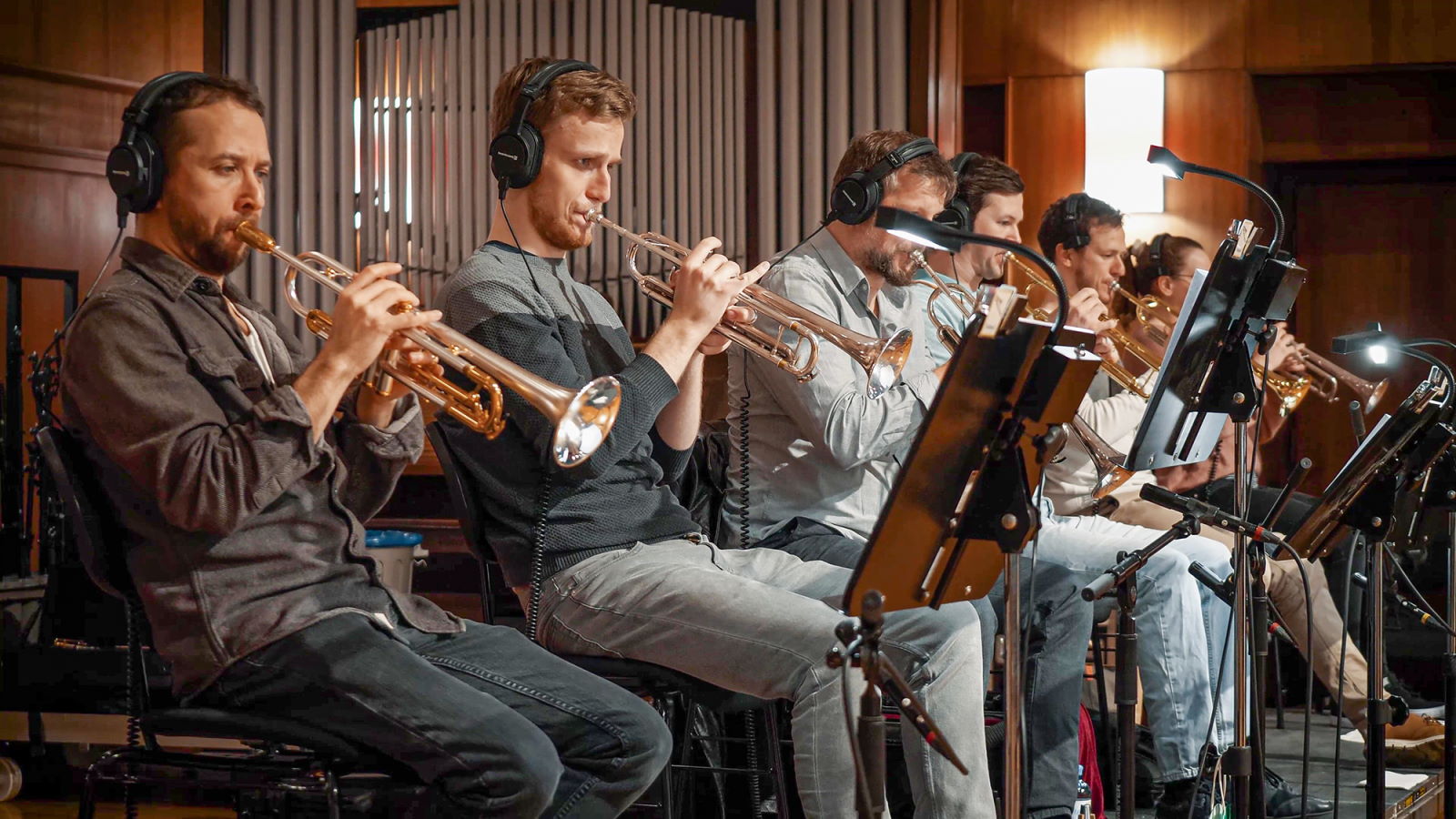 Synchron Percussion II: A variety of orchestral percussion instruments, including gongs, cymbals, and small bells, arranged on stands in a recording studio or concert hall.