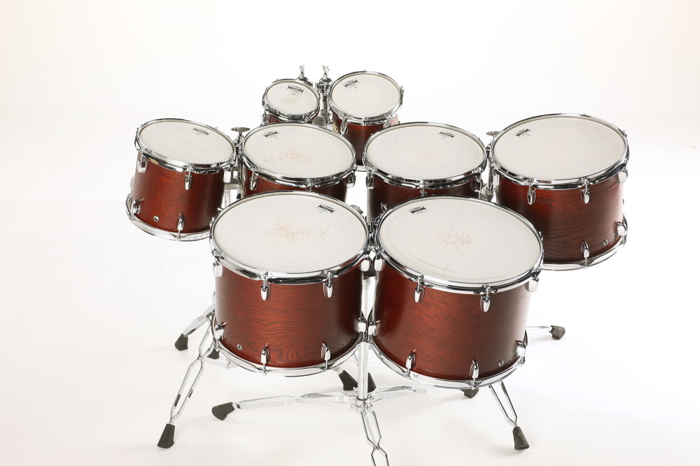 Full set of eight Synchron Percussion Drums, dark reddish-brown wood finish with white drumheads and chrome hardware, for sound recording.