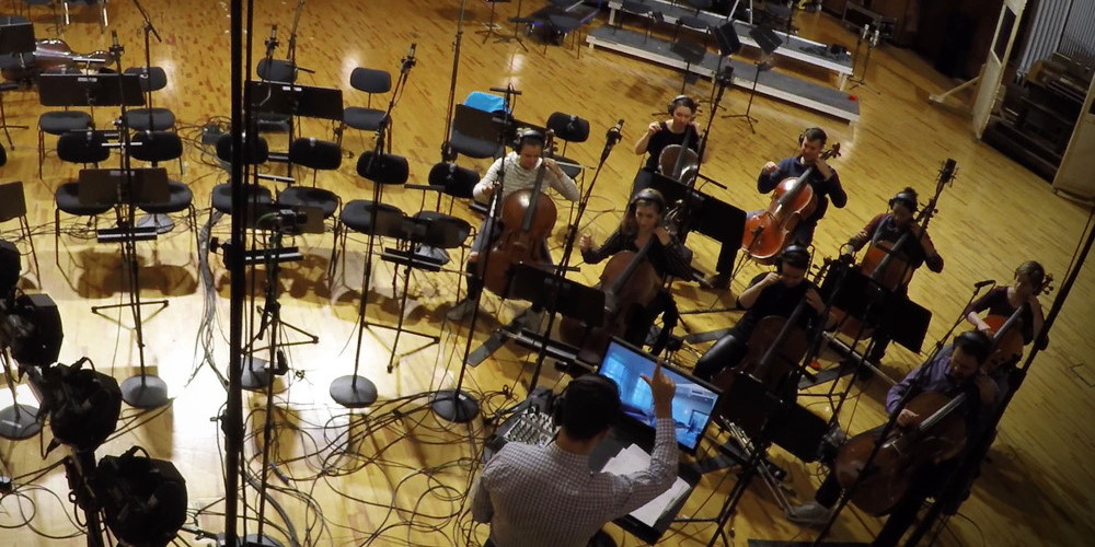Orchestra recording session at Synchron Stage A with cellists and conductor, Vienna Symphonic Library.