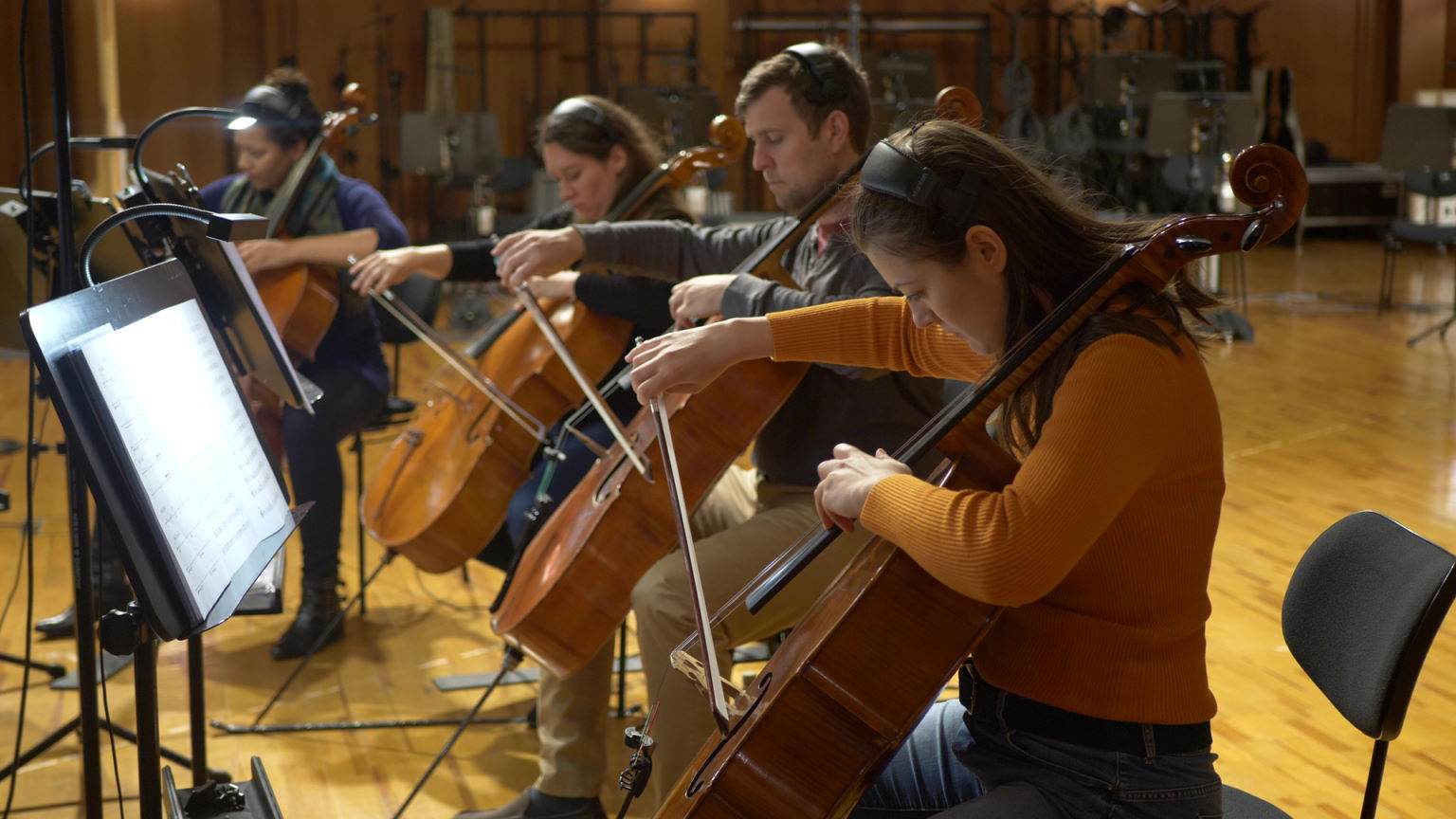 Synchron Percussion II: A variety of orchestral percussion instruments, including gongs, cymbals, and small bells, arranged on stands in a recording studio or concert hall.