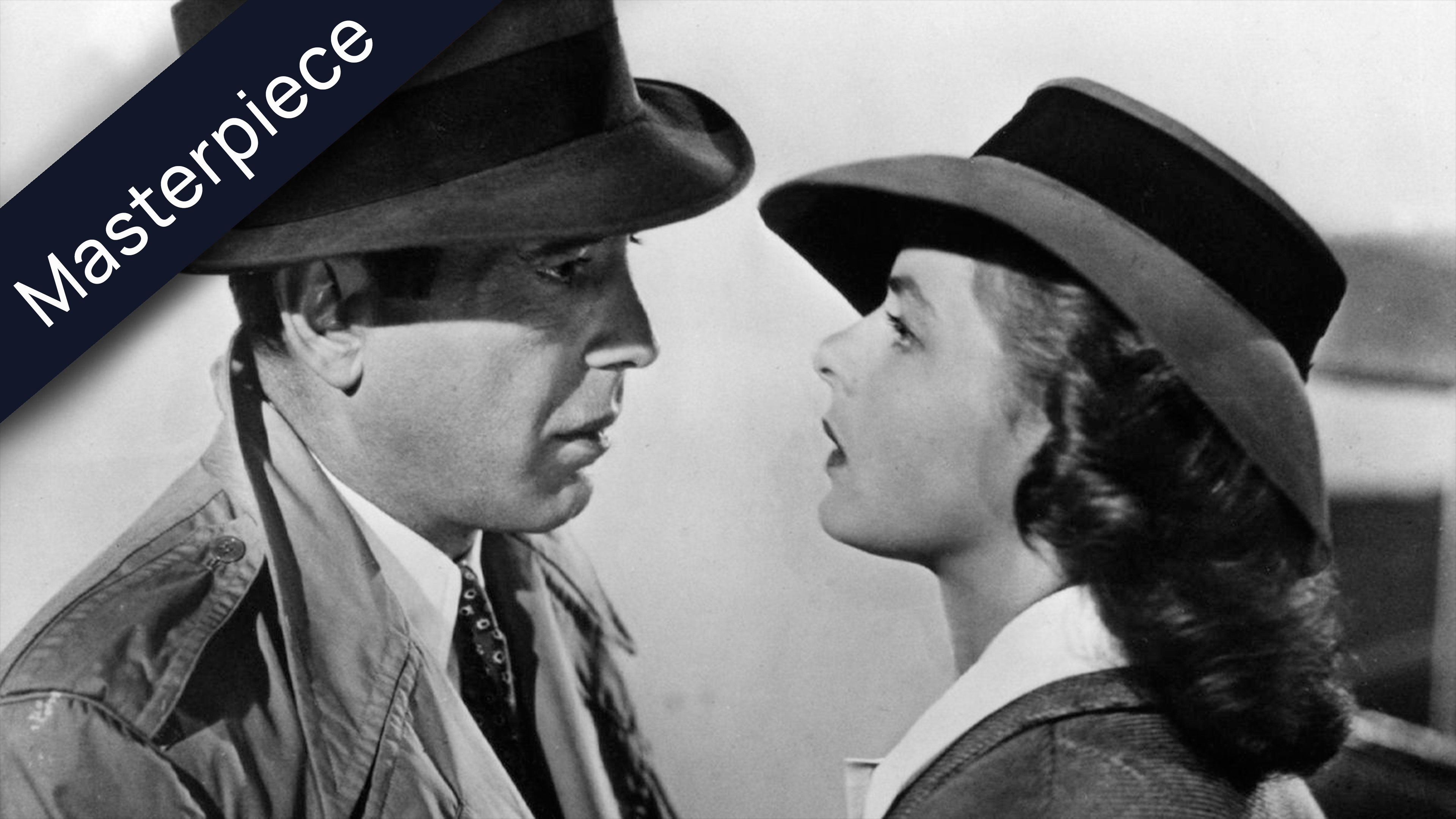 Black and white still from the movie Casablanca showing Humphrey Bogart and Ingrid Bergman, both wearing hats, looking at each other intently. The word Masterpiece is superimposed on the top left corner of the image.