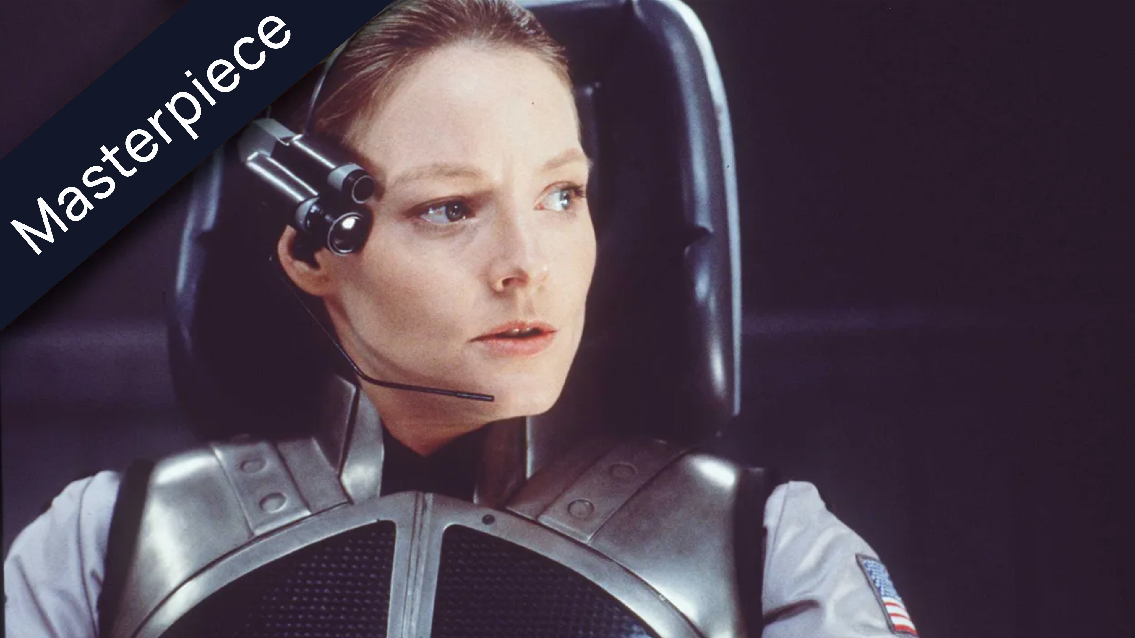 Jodie Foster as Dr. Ellie Arroway from the movie Contact, wearing a headset and pilot suit with a US flag patch, in a command chair, looking intently forward. The top left corner features a black ribbon with the white text Masterpiece.