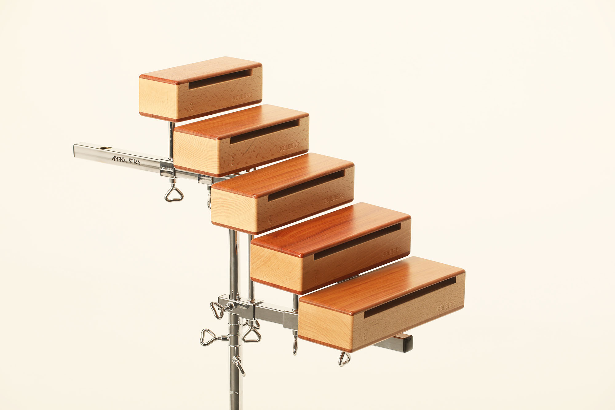 Kolberg wood blocks 1-6 set, light wood and reddish-brown tops, mounted on a silver stand, showing natural wood grain and Kolberg branding.