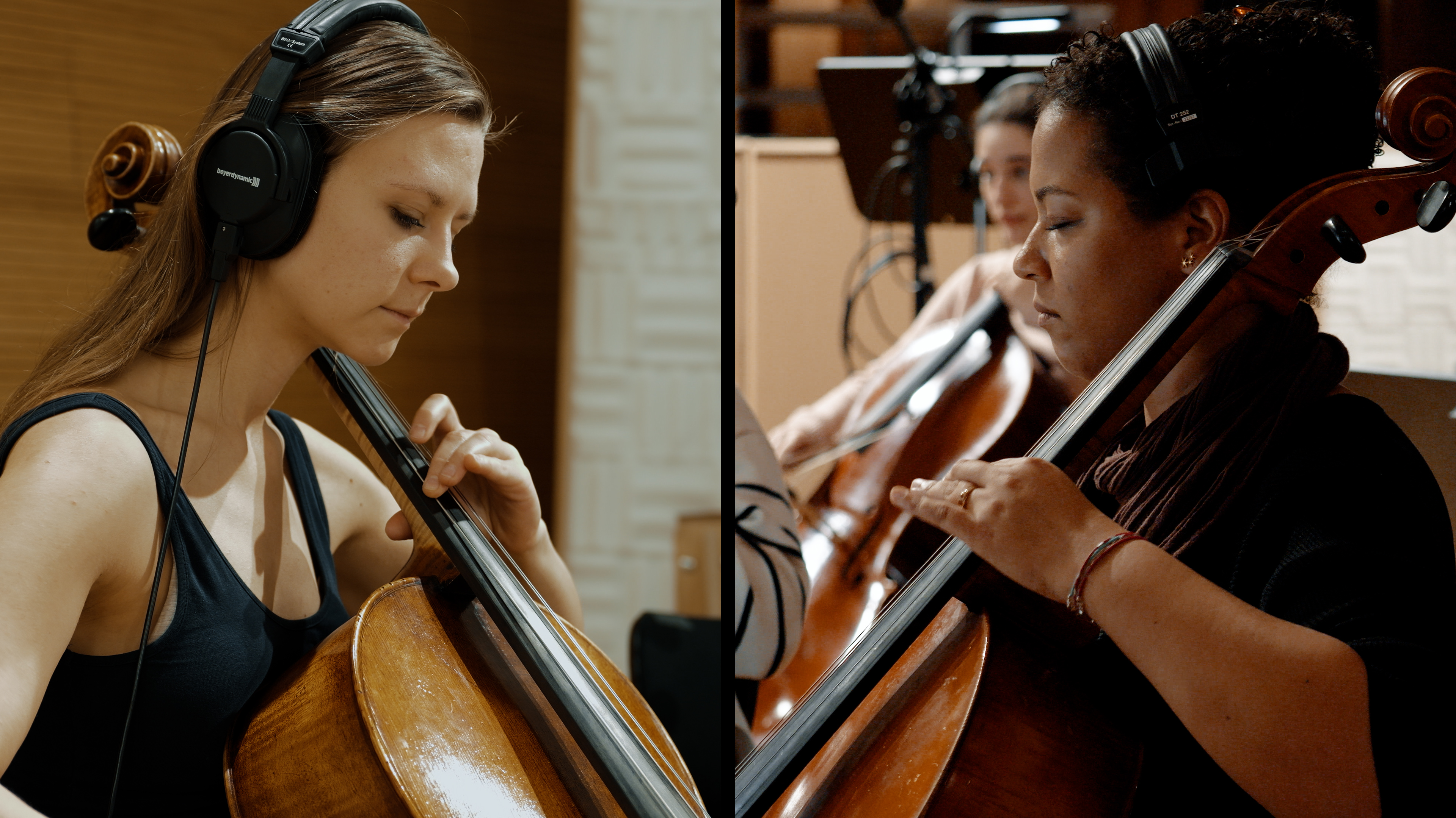 Two female cellists with headphones playing string instruments during a classical music recording session in a studio.