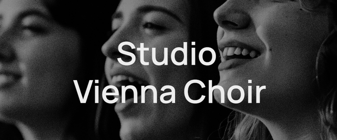 Black and white image of three smiling female singers with their mouths open, singing. Overlayed text reads Studio Vienna Choir.