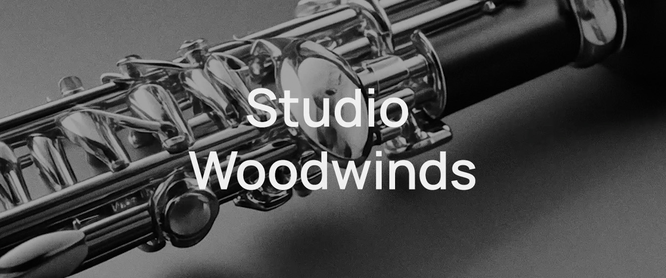 Close-up of a clarinet's silver keys and black body with the text Studio Woodwinds overlaid, emphasizing musical instruments and woodworking craftsmanship.