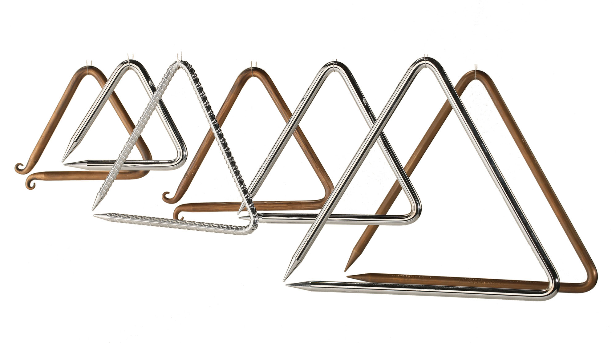 A row of six metal tent stakes forming triangles, alternating in material and color between brass-colored metal with a curved end and shiny chrome with a pointed end.