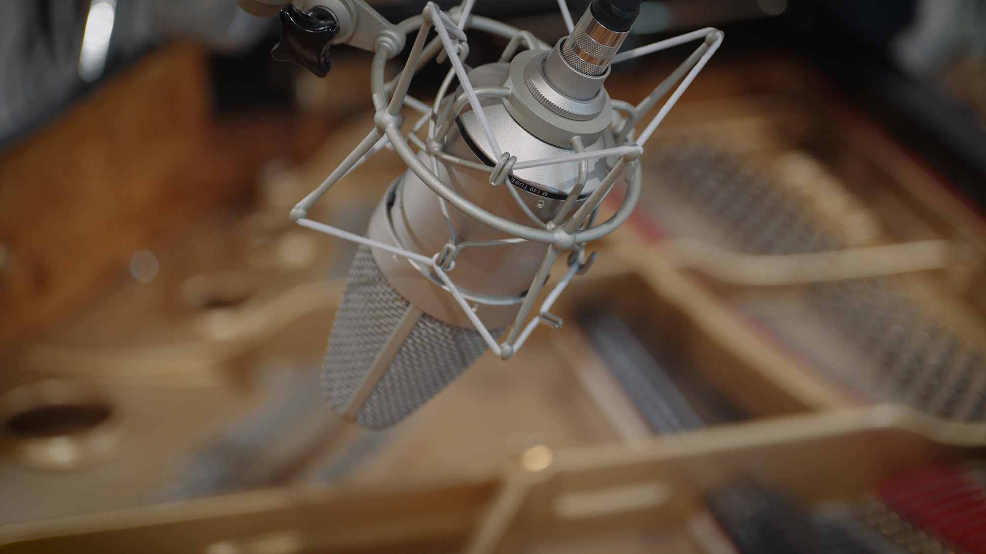 Neumann M 149 Tube condenser microphone suspended above a grand piano for audio recording