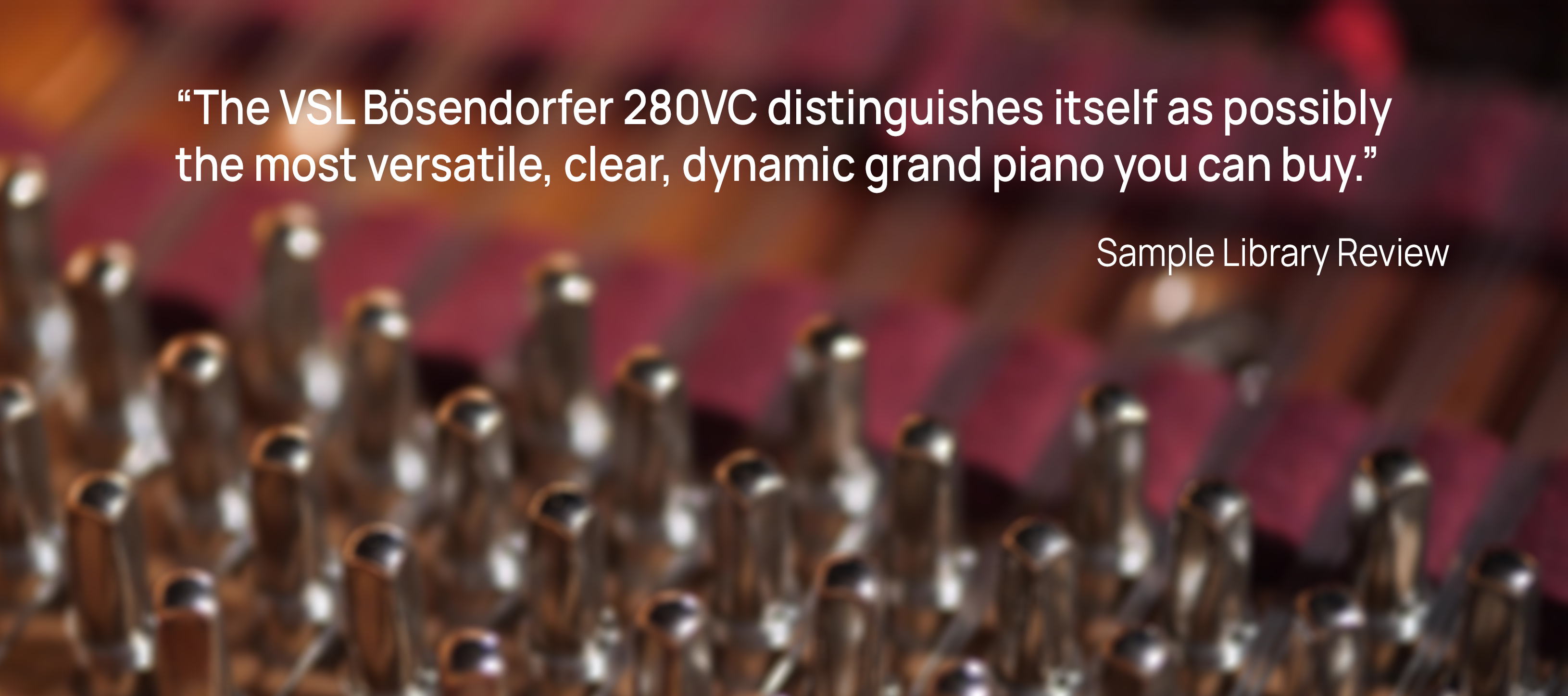 Close-up of shiny piano tuning pins and strings, with a blurred background showing the piano's red felt and wooden frame.